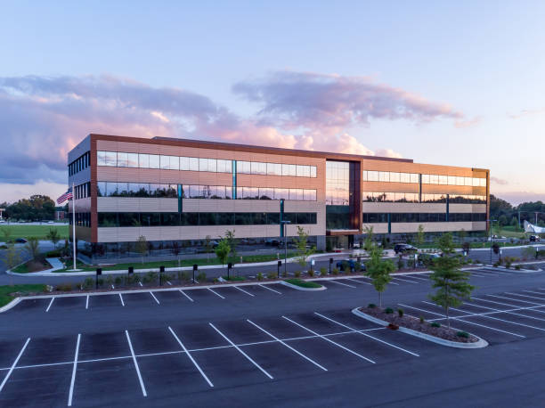 Evening shot of office building exterior with large parking lot