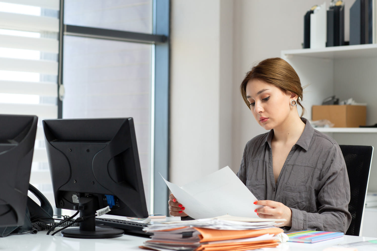 Lady in grey shirt working with the documents