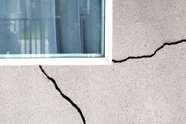 Visible cracks forming in concrete foundation