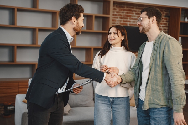 Real Estate appraiser talking greeting clients.