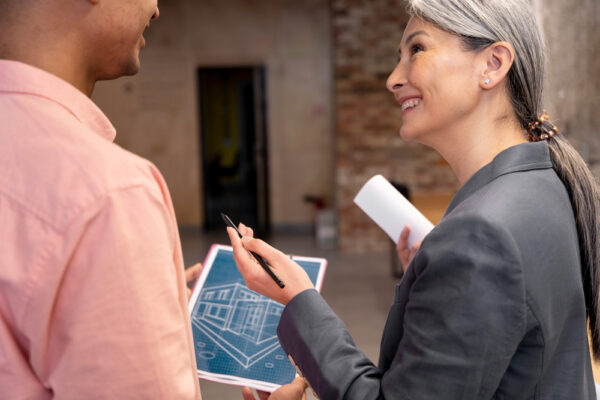 real estate appraiser reviewing exterior of a house