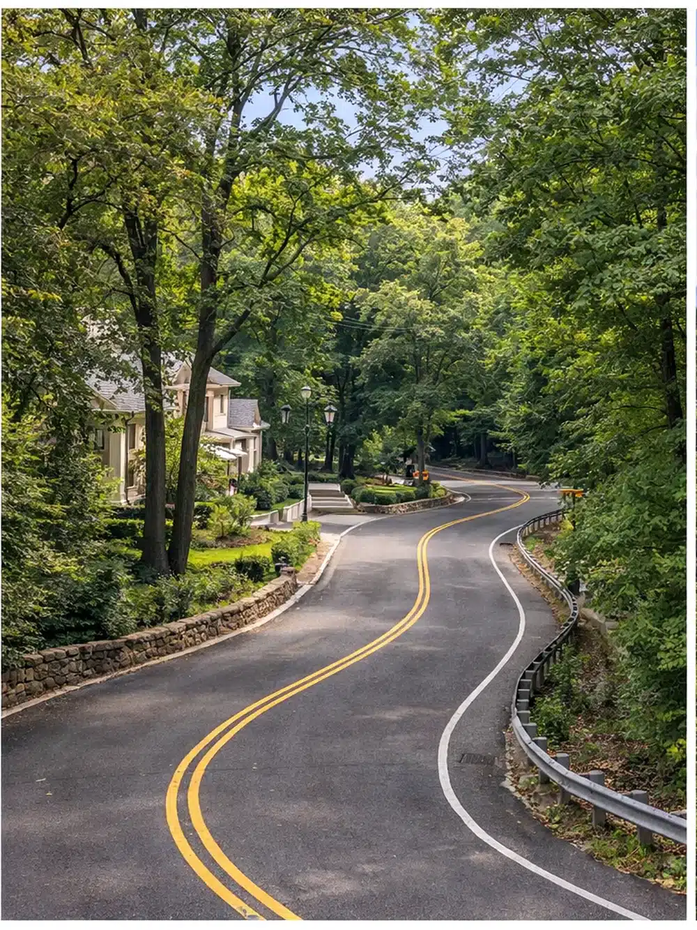 Winding residential road through the wooded hills of Todt Hill, Staten Island.